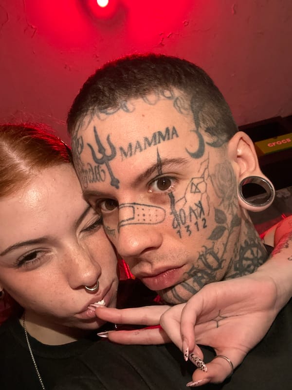 Intimate couple photographed under red lighting in Buenos Aires