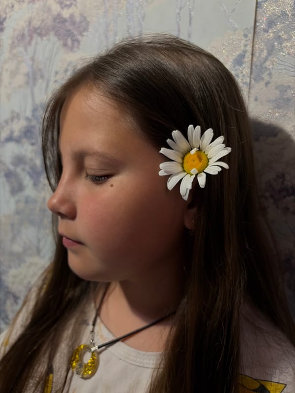 Person documented in intimate domestic moments with baby, daisies