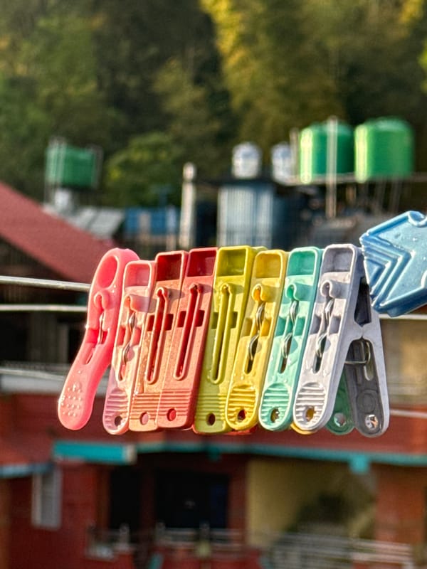 Colorful clothespins spotted on wire in Pokhara cityscape