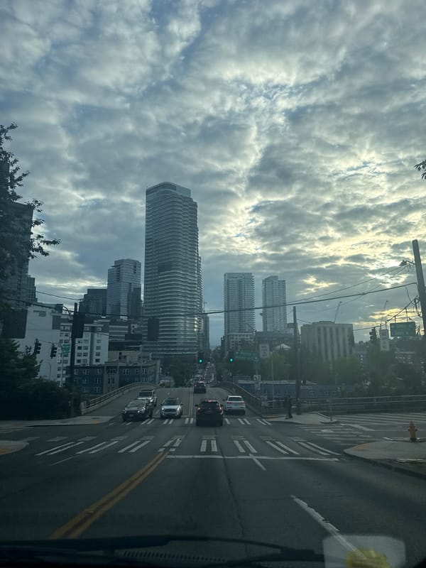 Downtown city streets, skyscrapers, and a painted utility box