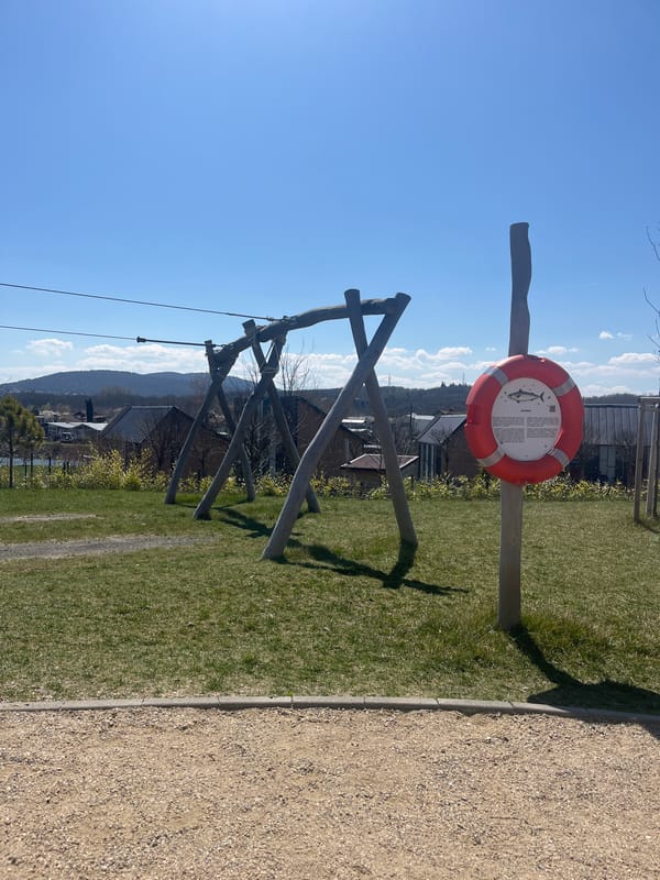 Child rides zip line at Burgas playground with adult supervision