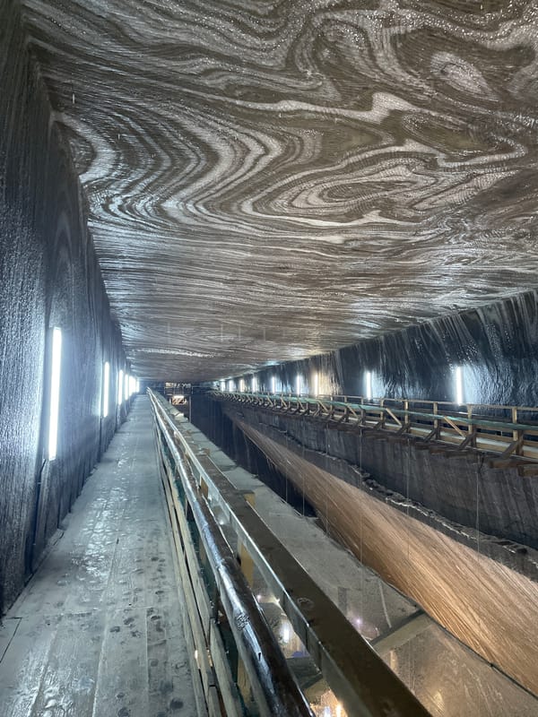 Visitor documents Turda Salt Mine interior spaces in Romania