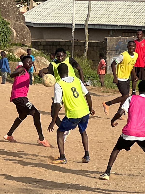 Pickup soccer on a rocky dirt field in Jos, Nigeria