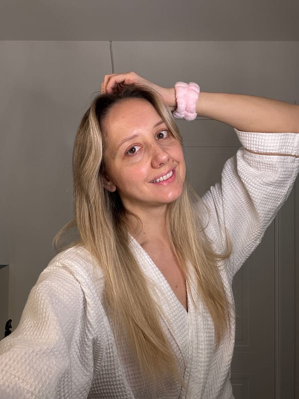 Woman performs evening skincare routine in Carnikava bathroom