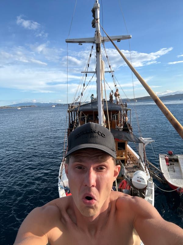 Man takes selfie aboard sailing ship near Pasir Putih