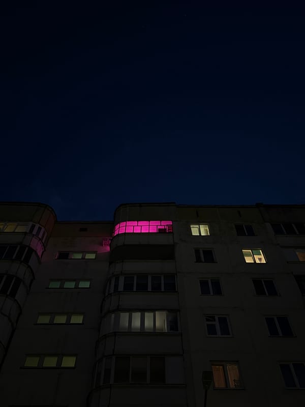 Perm building displays pink-glowing windows at night