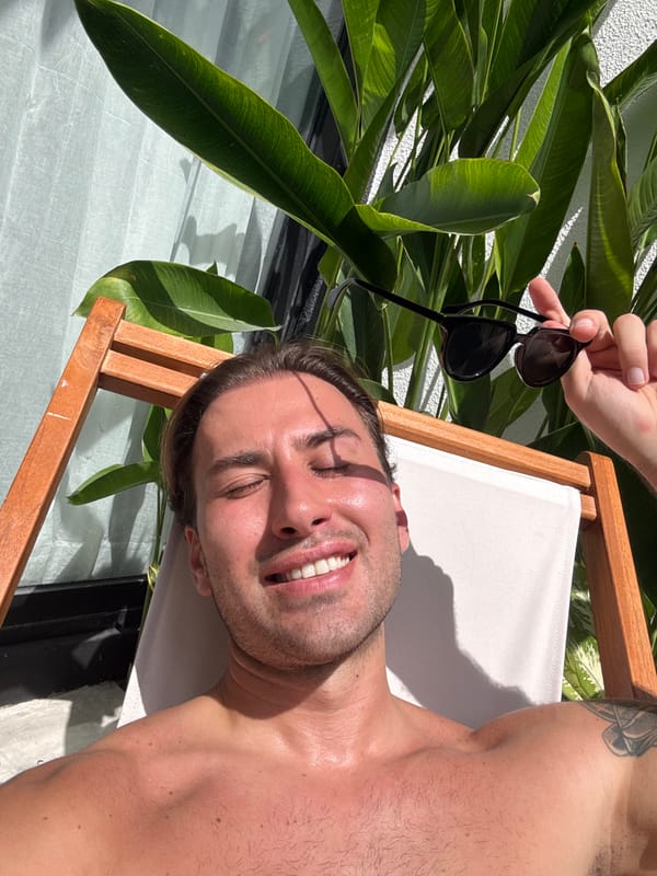 Man enjoys sunny relaxation on beach chair in North Kuta