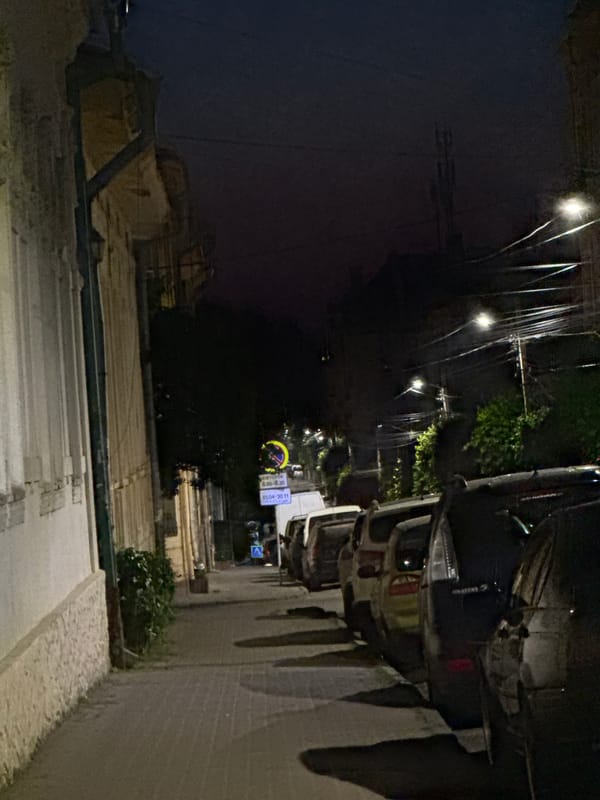 Full moon over parked cars on a quiet Chernivtsi street