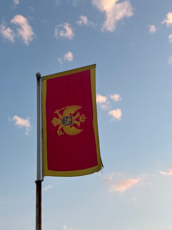Montenegro flag observed flying in Podgorica under cloudy skies