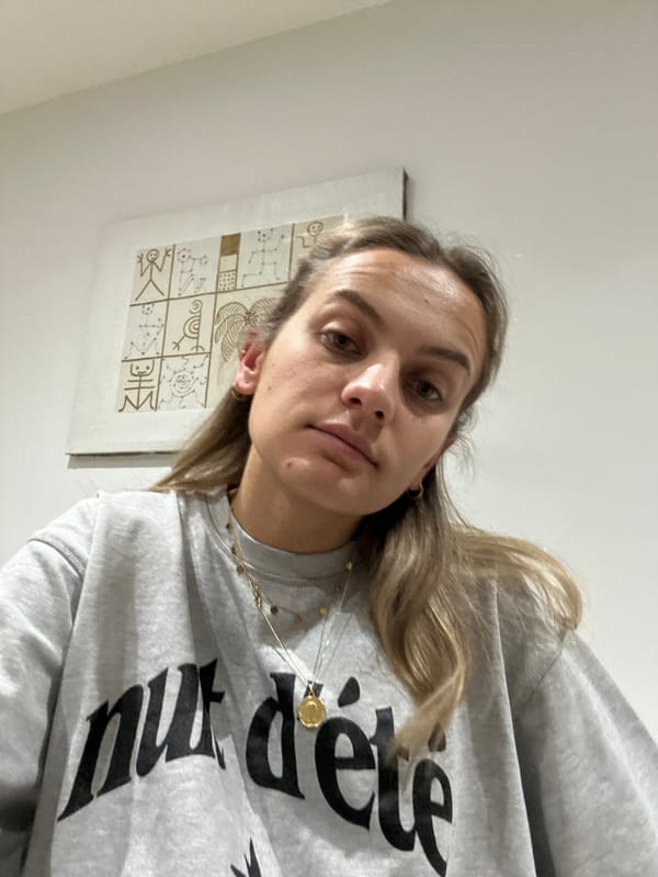 Woman documents evening skincare routine in French bedroom