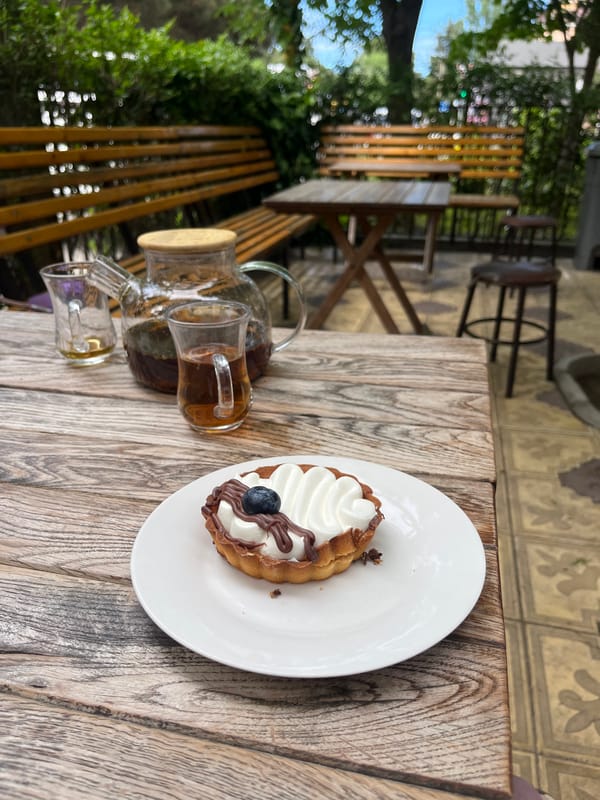 Children enjoy cake and tea at outdoor cafe in Kaspiysk