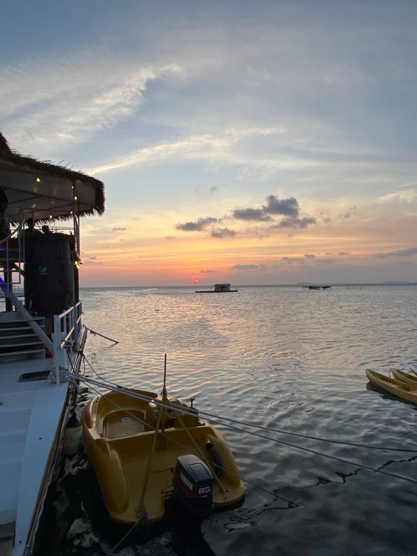 Dusk at an overwater bar in Karimunjawa, full moon rising