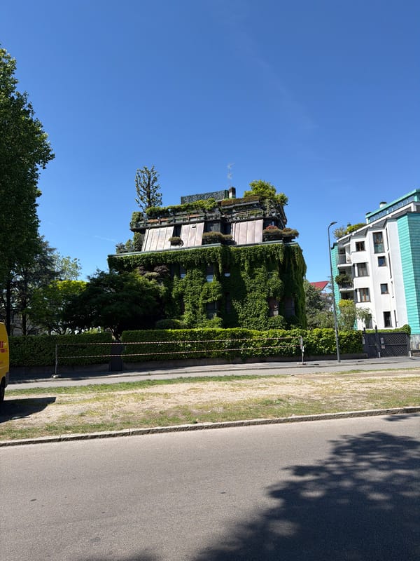 Green-integrated buildings observed in sunlit Milan street scene