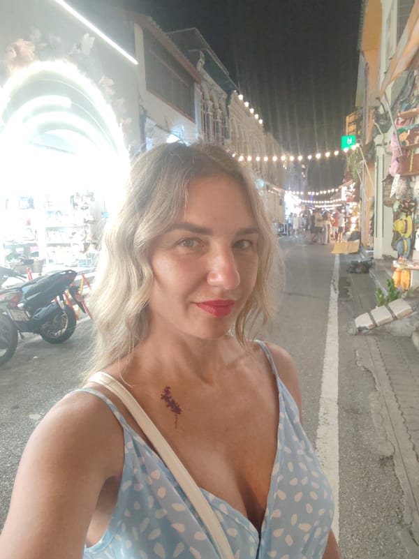 Woman takes selfie on bustling Phuket street