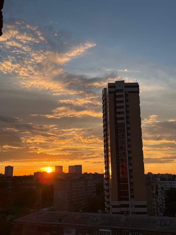Urban sunset illuminates residential towers across city landscape