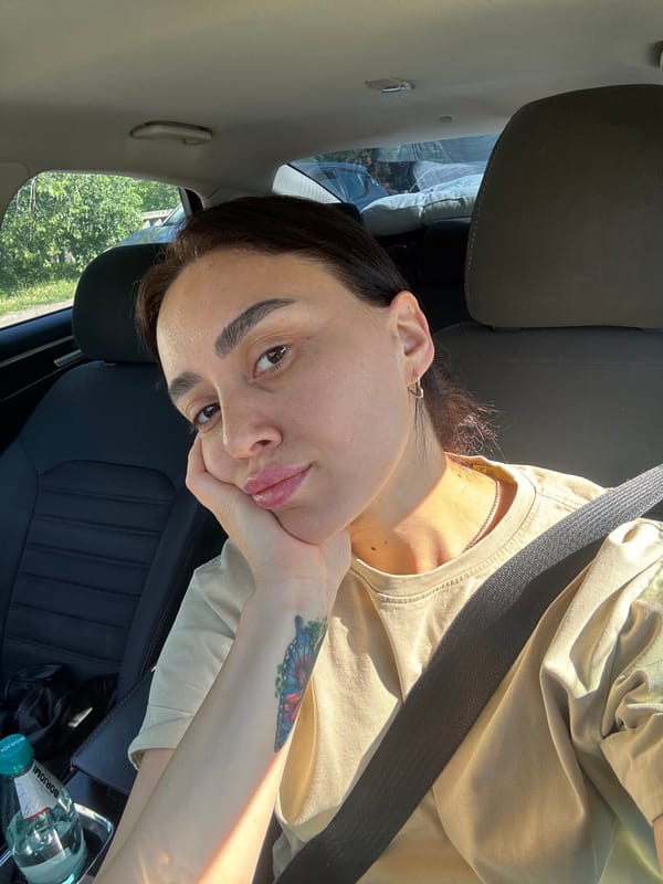 Woman takes morning selfies in car in Tbilisi