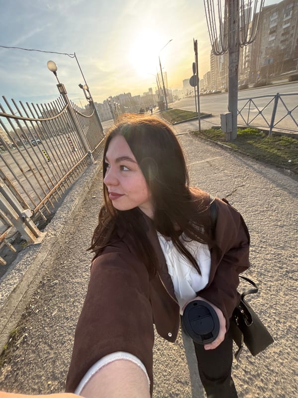 Woman takes sunset selfie on Perm street