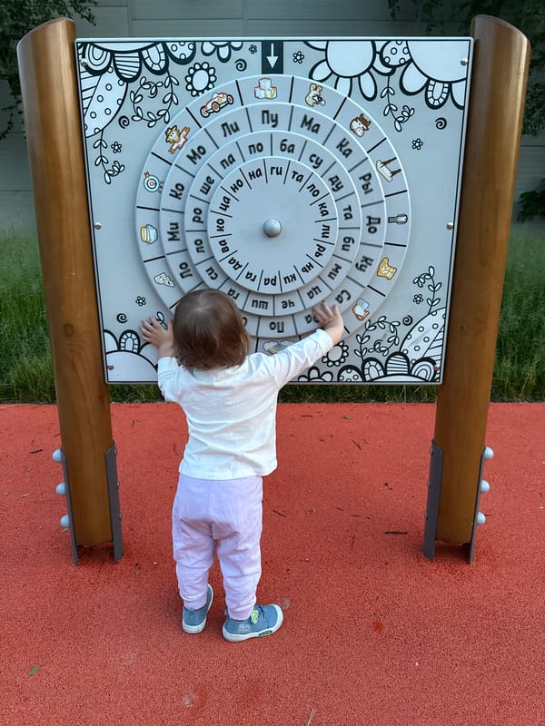 Child and adult enjoy playground activities in Moscow park