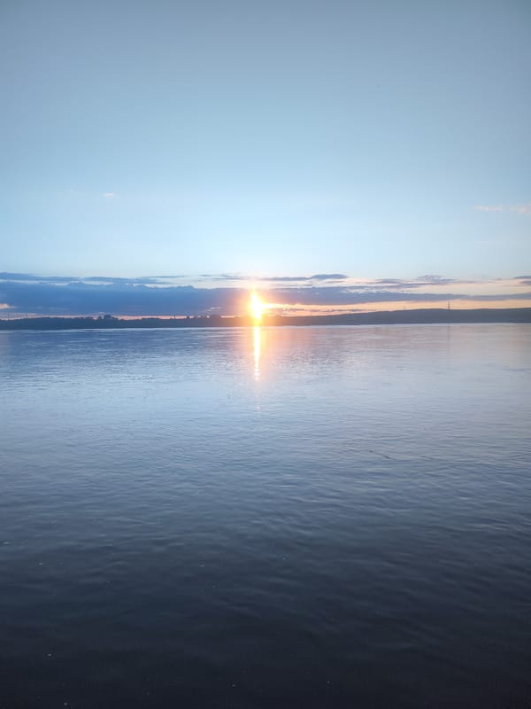 Sunset documented over water body near Noviy, Russia