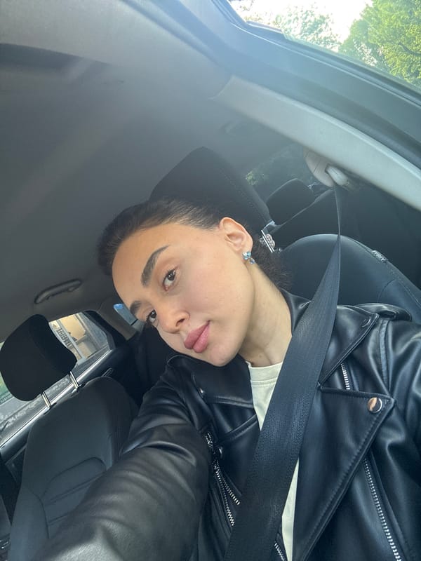 Woman in leather jacket photographed in car in Tbilisi