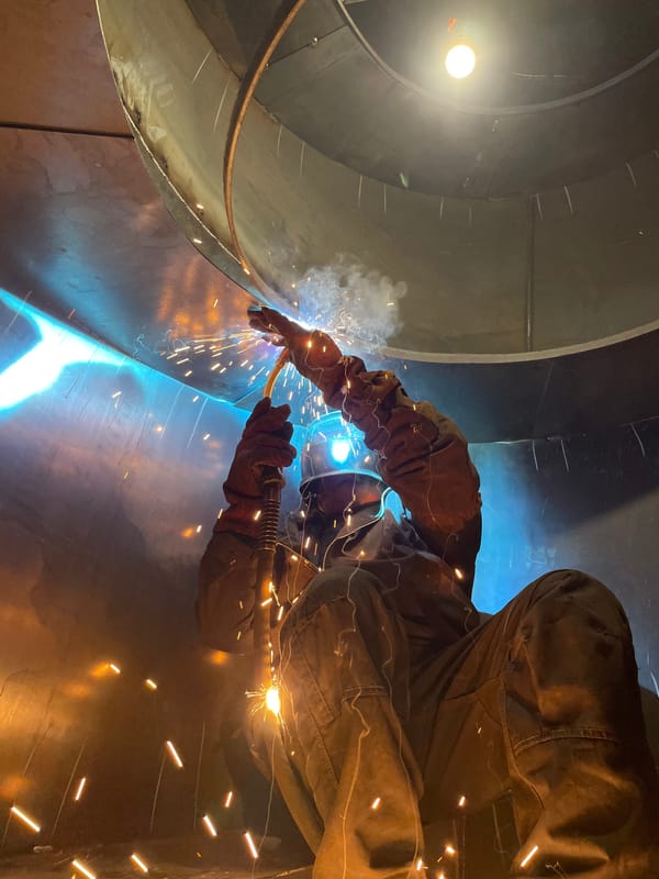 Worker grinds metal with protective gear in Montenegro building