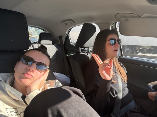 Two women take Sunday car trip through Bulgarian village