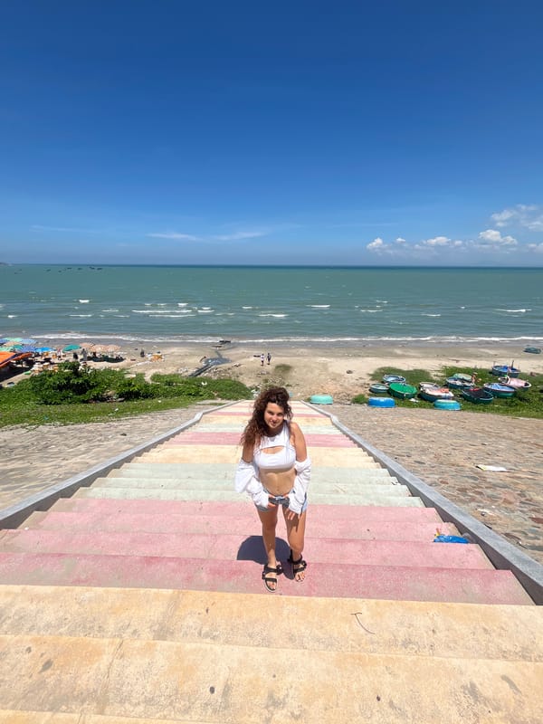 Posing along Mũi Né's colorful beachfront staircase and walkway