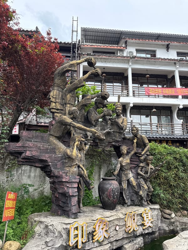 Morning scenes documented in Wulingyuan featuring sculpture, architecture, vehicle