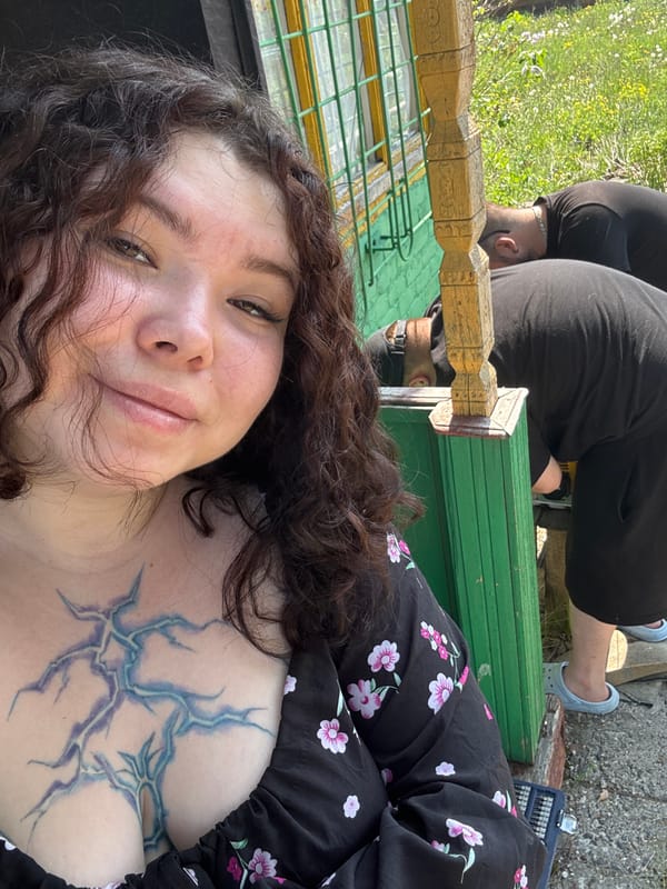 Woman takes selfies outside wooden house in Surgut