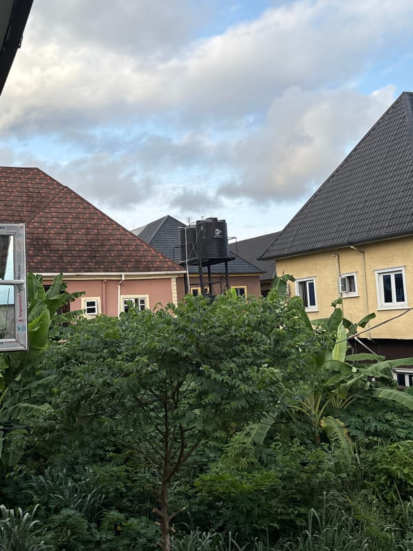Obosi residential streets under heavy clouds, July afternoon