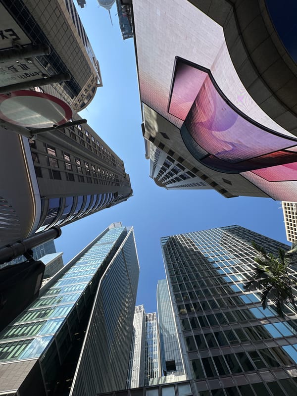 Street-level look up at Hong Kong's glass and steel skyline
