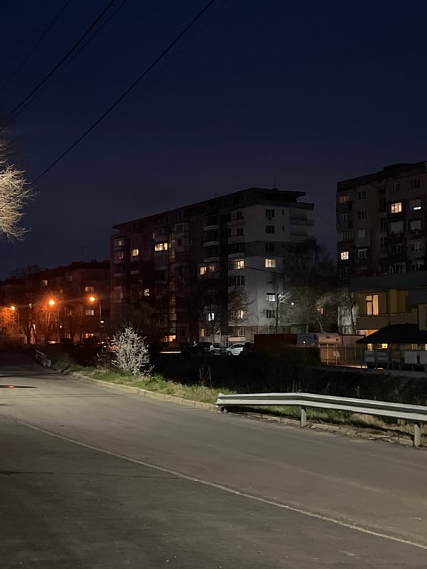 Evening lights illuminate apartment building in Pernik, Bulgaria