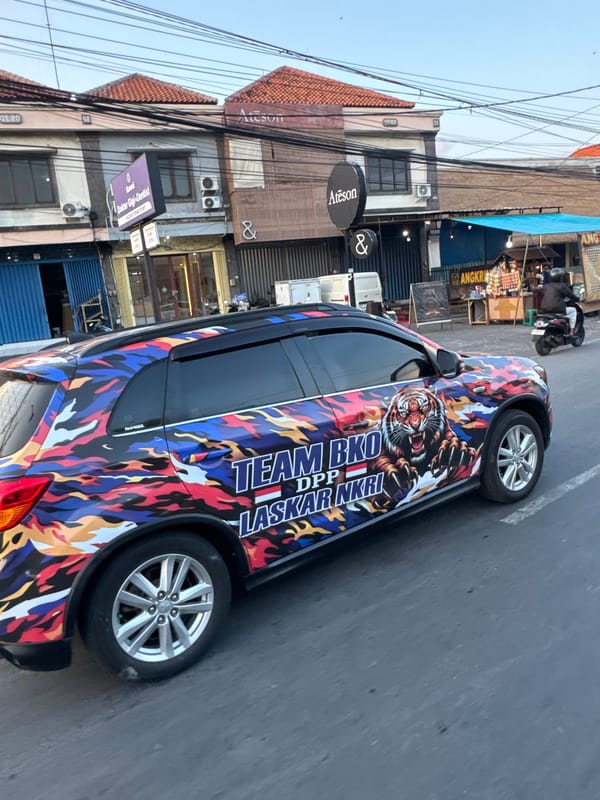 Denpasar evening rush hour, sunset light, camouflage car in traffic