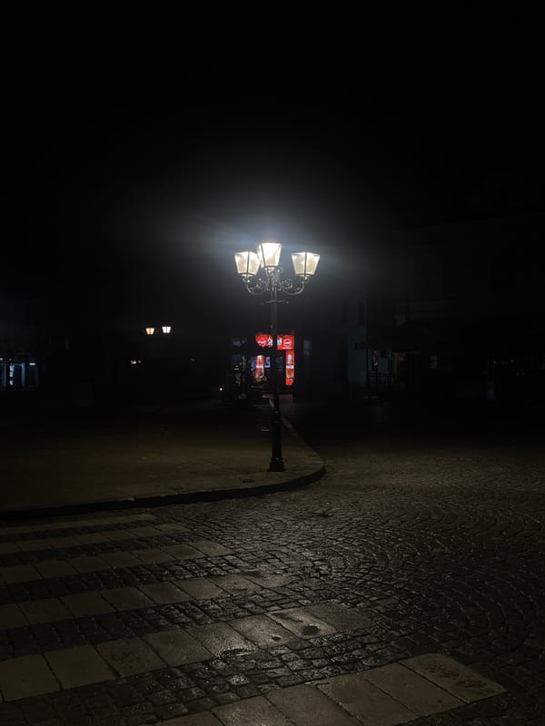 Nighttime street lamps illuminate cobblestone roads in Tryavna, Bulgaria