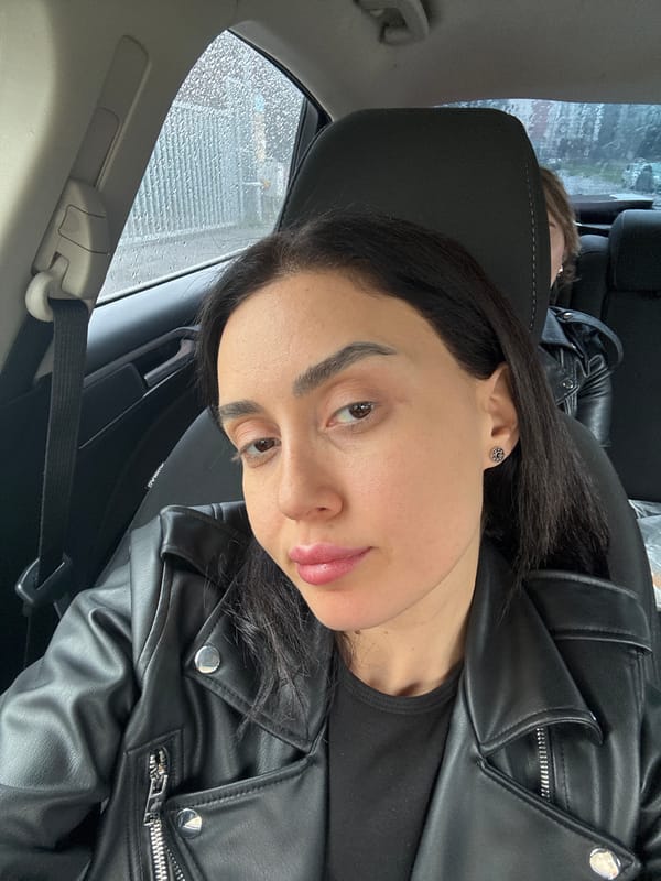 Woman takes car selfies during rainy morning in Tbilisi