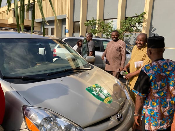 Community meeting and car inspection gathering in Umuahia, Nigeria