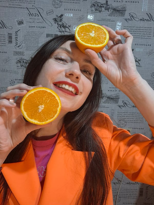 Woman poses with citrus and grapes in playful photo session