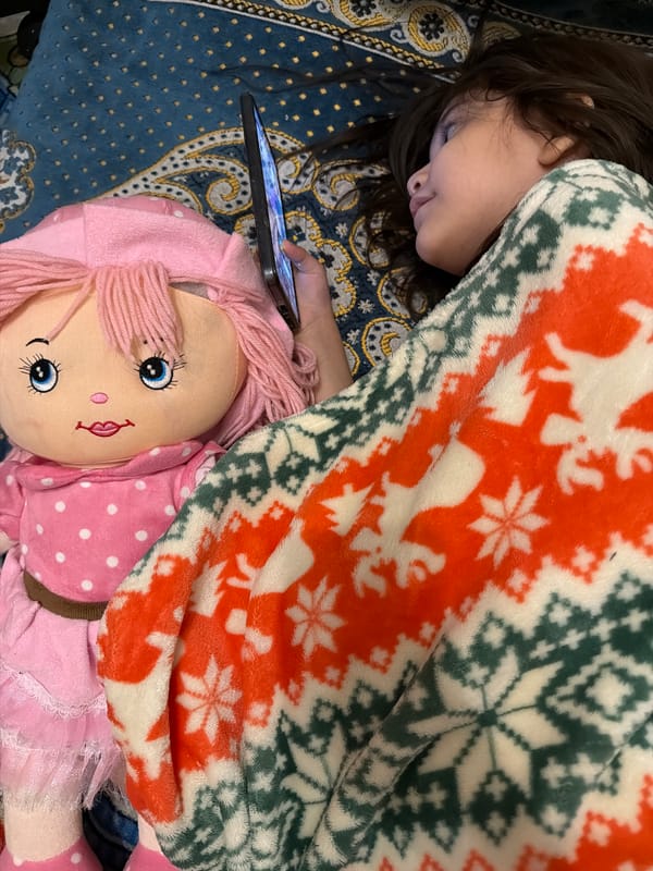 Girl rests with smartphone on holiday blanket in Orenburg