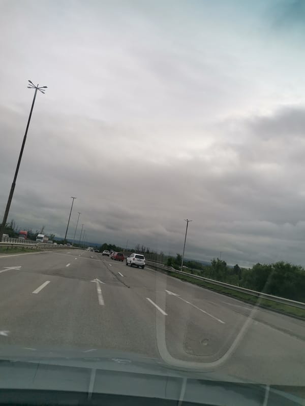 Highway journey documented during overcast morning commute conditions