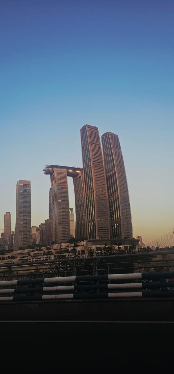 Raffles City Chongqing towers under a clear Nan'an sky
