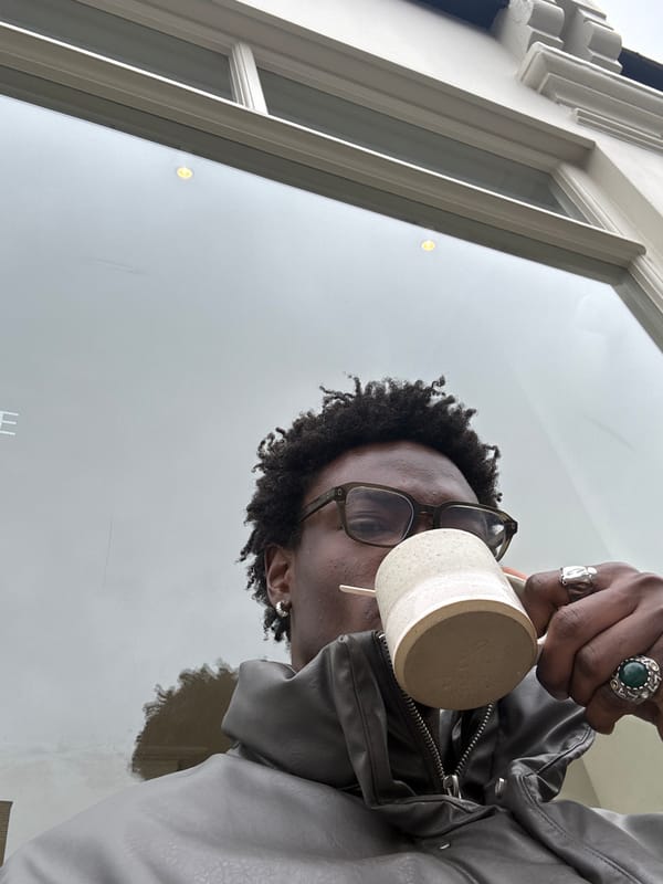 Person enjoys hot drink on London street