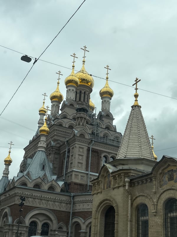 Saint Petersburg street-level mix: domes, cranes, trams, and facades