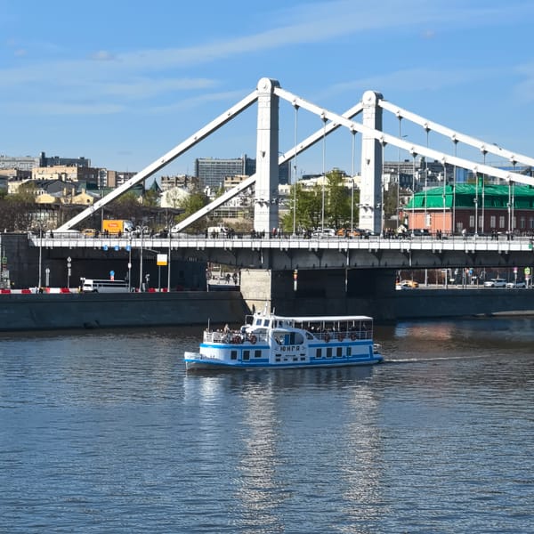 Passenger boat sails under Crimean Bridge on Moscow River