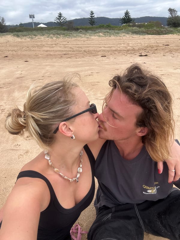Couple shares Valentine's moment with playful dog on Wollongong beach