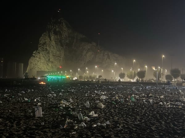 Bonfire and beach litter at night near Gibraltar