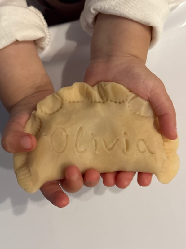 Child enjoys personalized pastry in high chair in Wisła