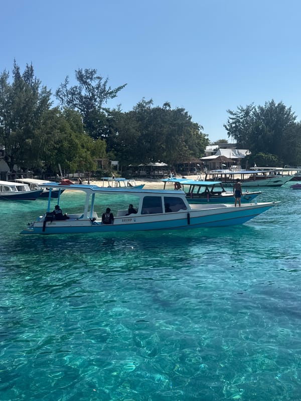 Passenger boat docked at a small Indonesian coastal pier
