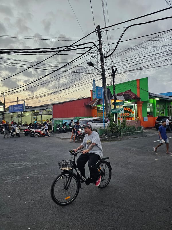 Everyday traffic flows through Denpasar streets on an overcast morning