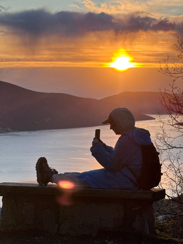 Person watches sunset over Bay of Kotor, Montenegro