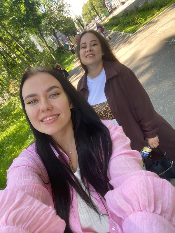 Two women enjoy sunny day at Perm amusement park